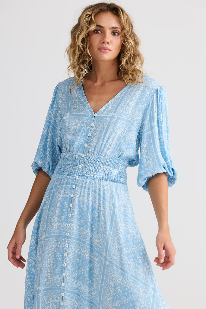 Woman wearing a light blue dress with a white background