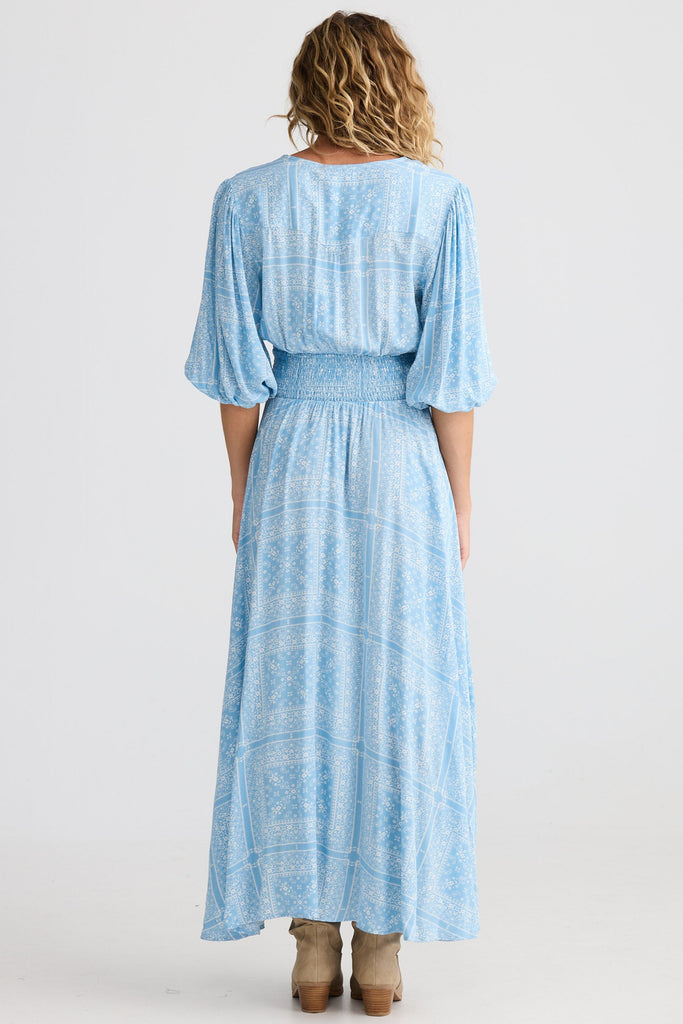 Woman wearing a light blue dress with a white background