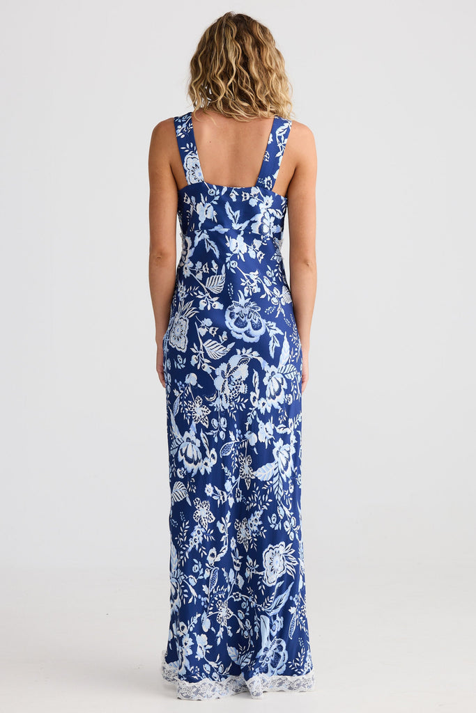 Woman wearing a blue floral dress on a white background