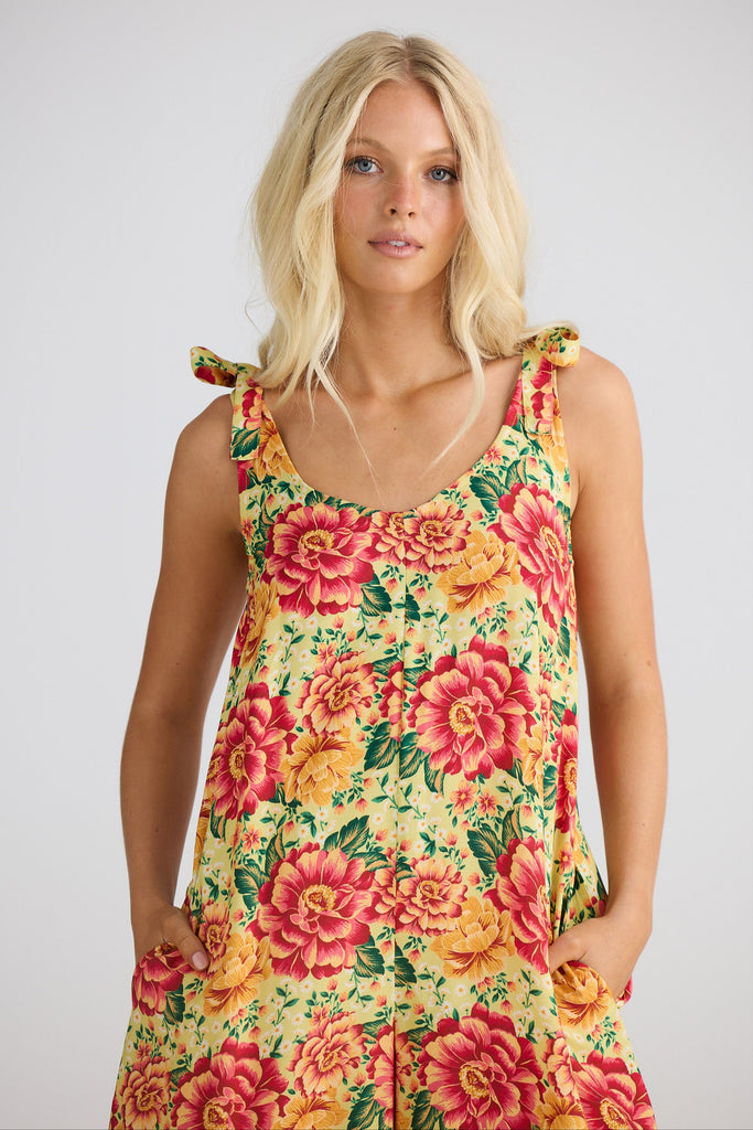 Woman wearing a floral dress with a plain background