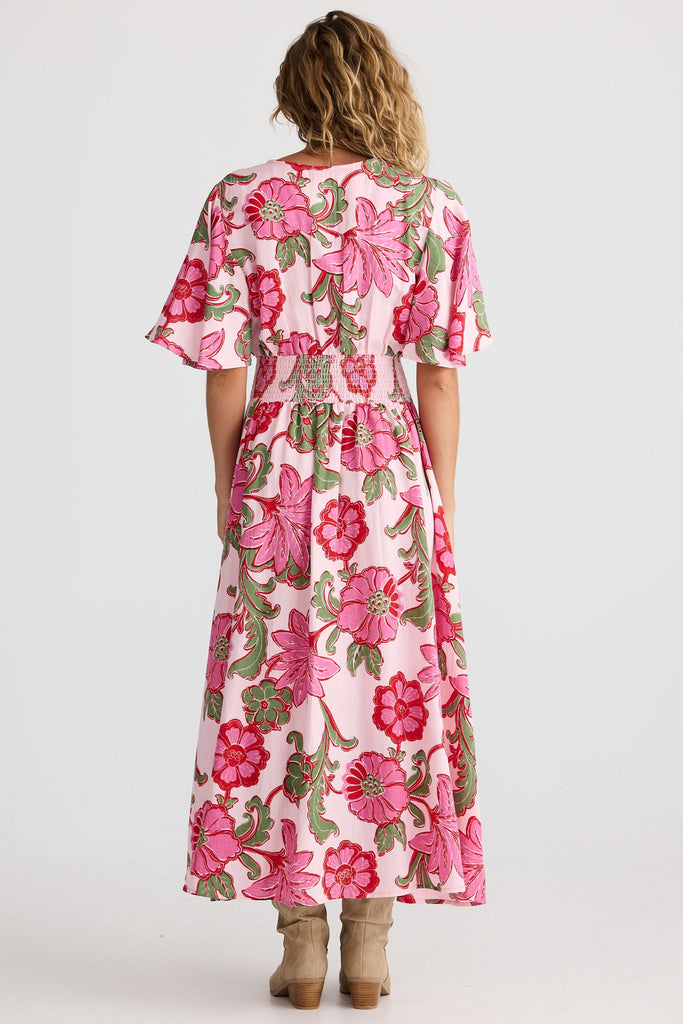 Woman wearing a pink floral dress on a white background