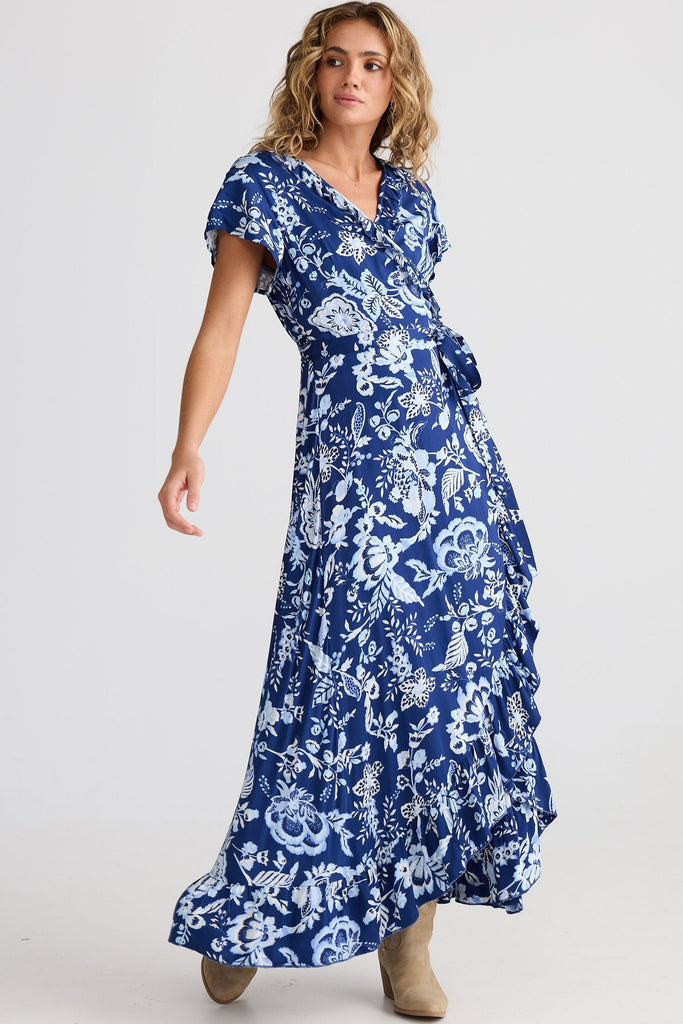 Woman wearing a blue floral dress on a white background