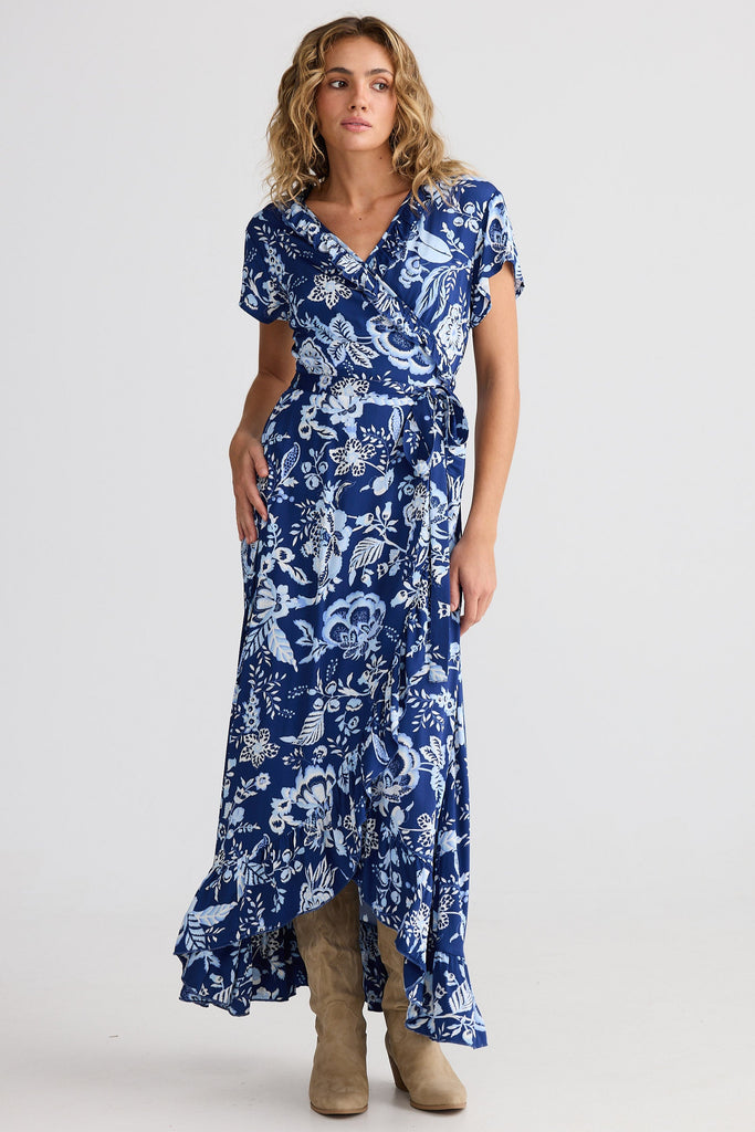 Woman wearing a blue floral dress on a white background