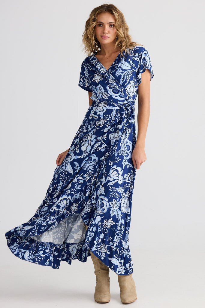Woman wearing a blue floral dress on a white background