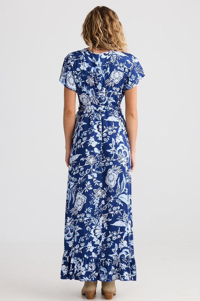 Woman wearing a blue floral dress on a white background