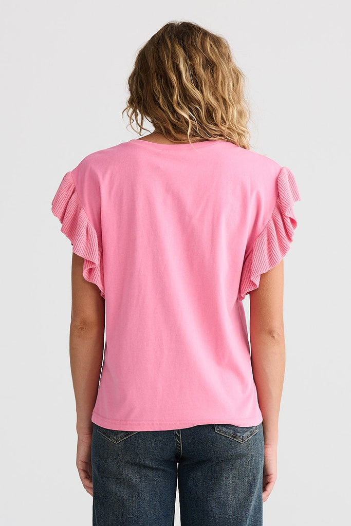 Person wearing a pink top and blue jeans on a white background