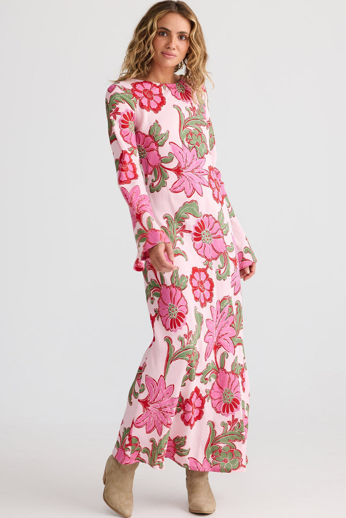Woman wearing a pink floral dress on a white background