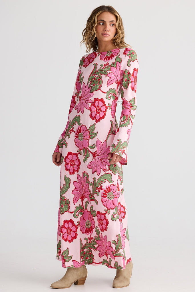 Woman wearing a pink floral dress on a white background