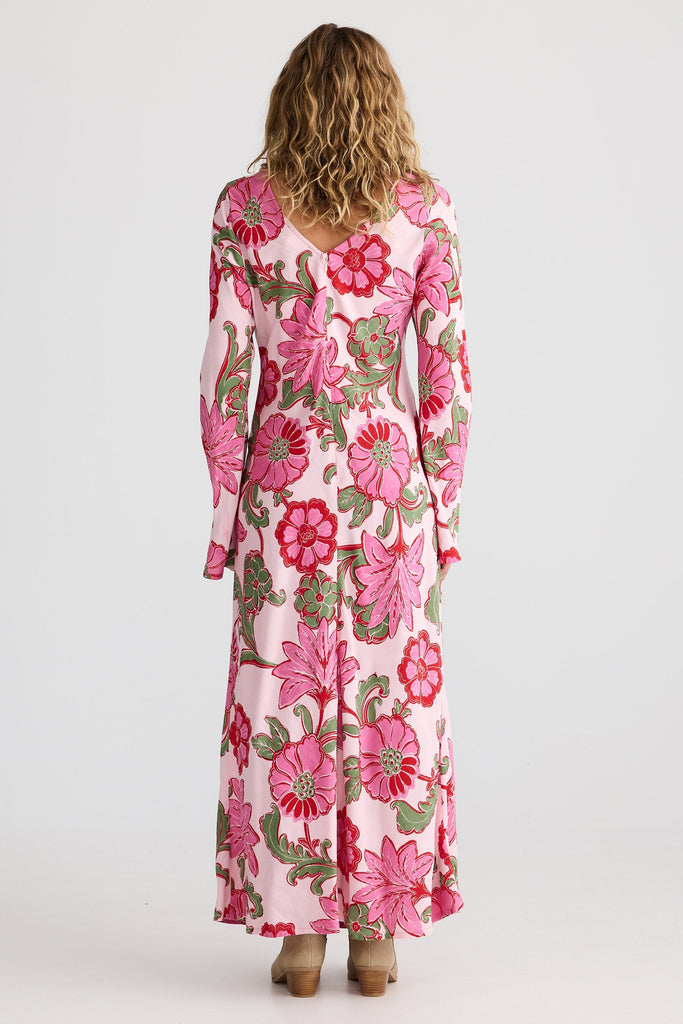 Woman wearing a pink floral dress on a white background