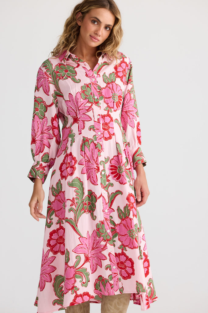 Woman wearing a pink floral dress on a white background