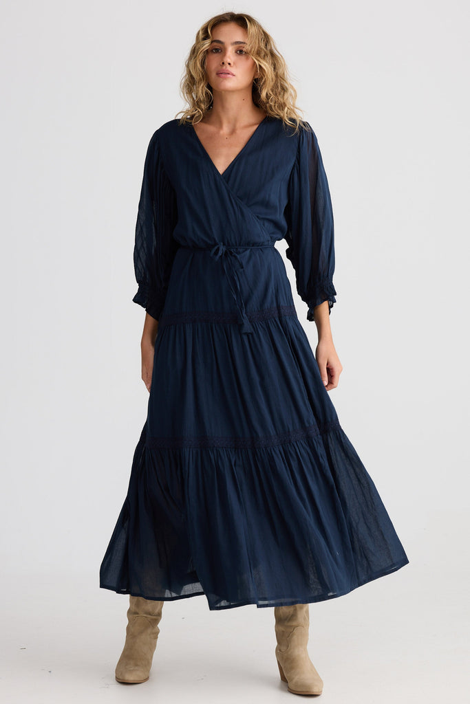 Woman wearing a navy blue dress on a white background