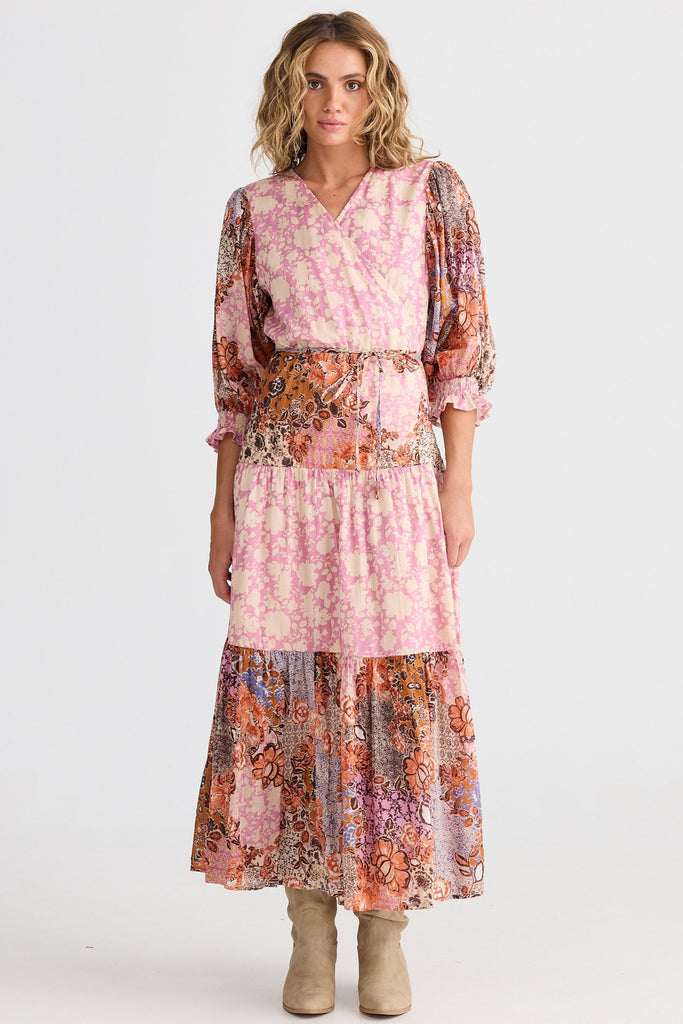 Woman wearing a pink floral dress on a white background