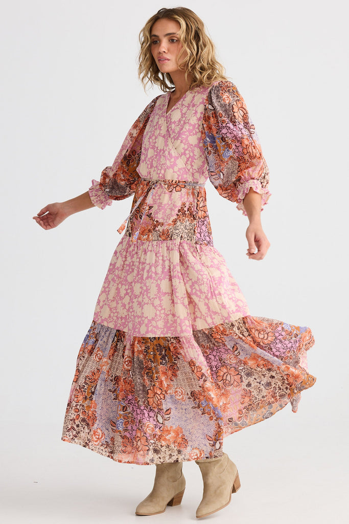 Woman wearing a pink floral dress on a white background