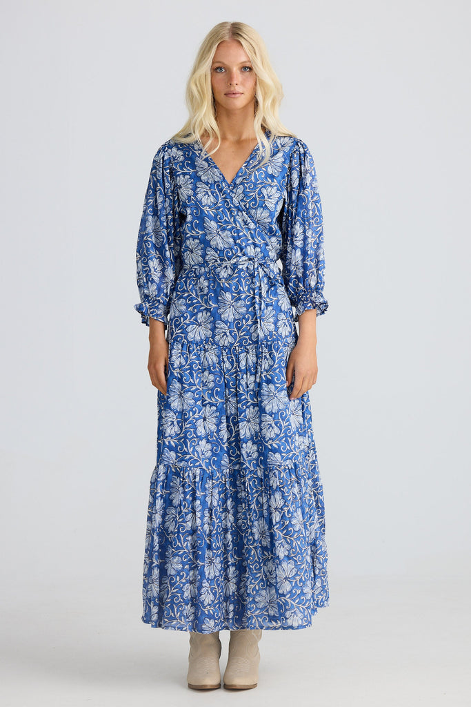 Woman wearing a blue floral dress on a white background