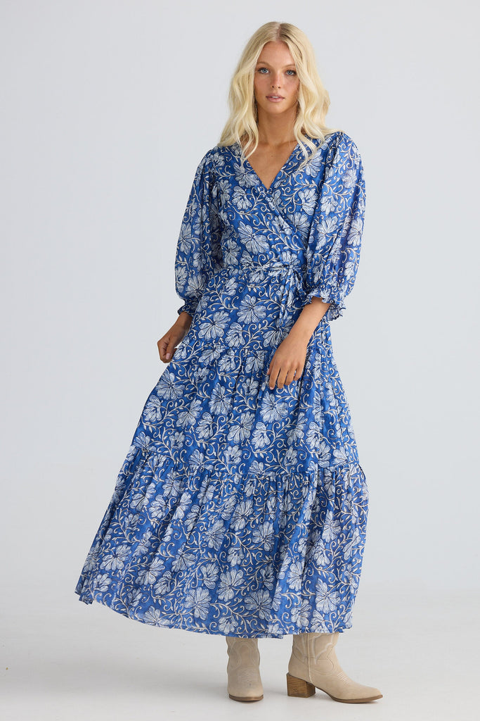 Woman wearing a blue floral dress on a white background