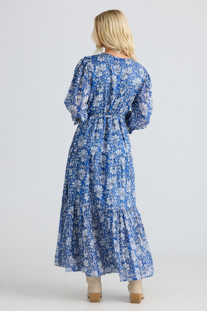 Woman wearing a blue floral dress on a white background