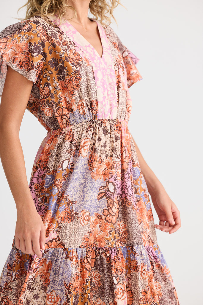 Woman wearing a floral dress with a neutral background