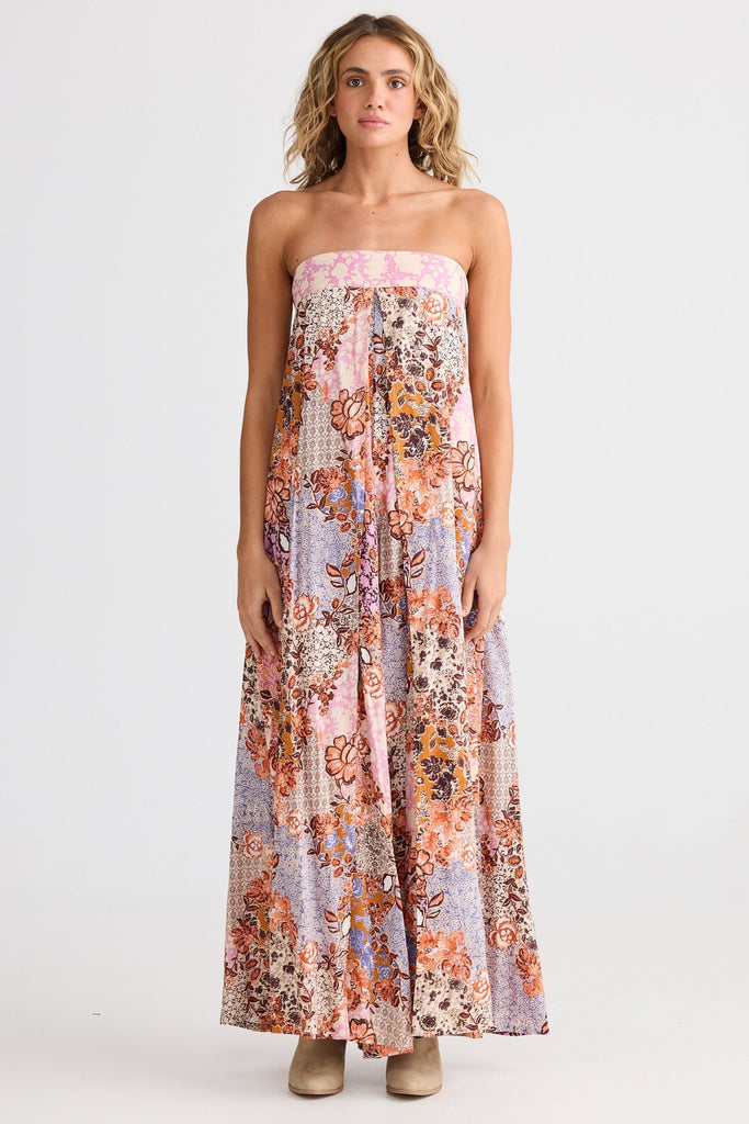 Woman wearing a floral strapless dress on a white background