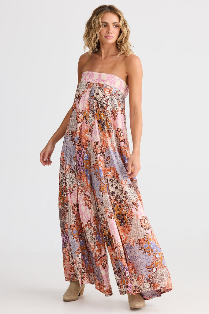 Woman wearing a floral strapless dress on a white background