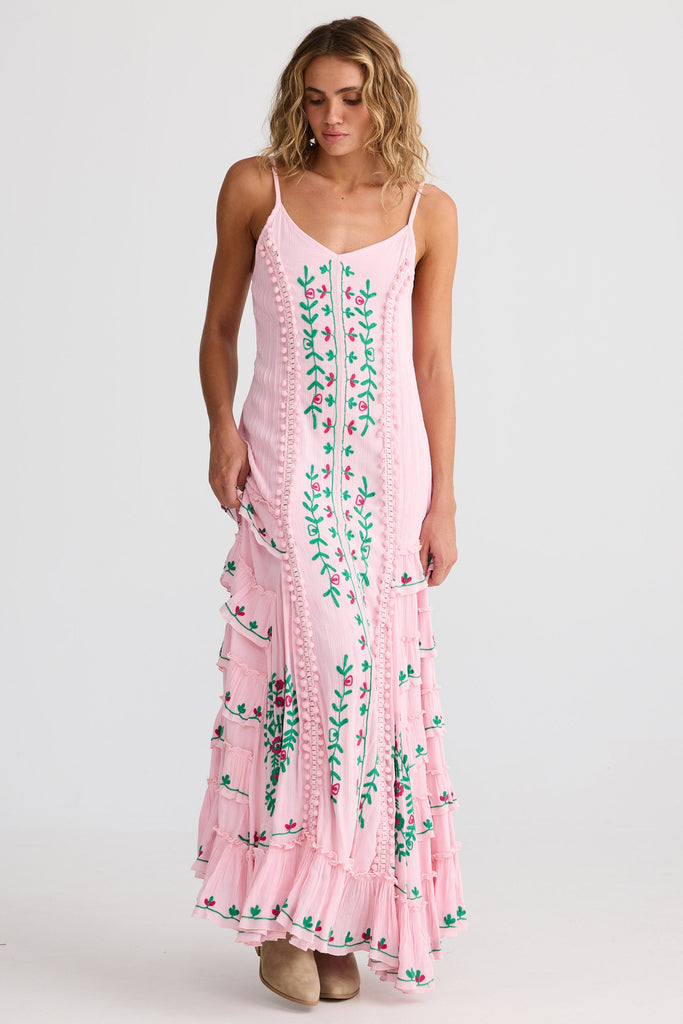 Woman wearing a pink floral dress on a white background