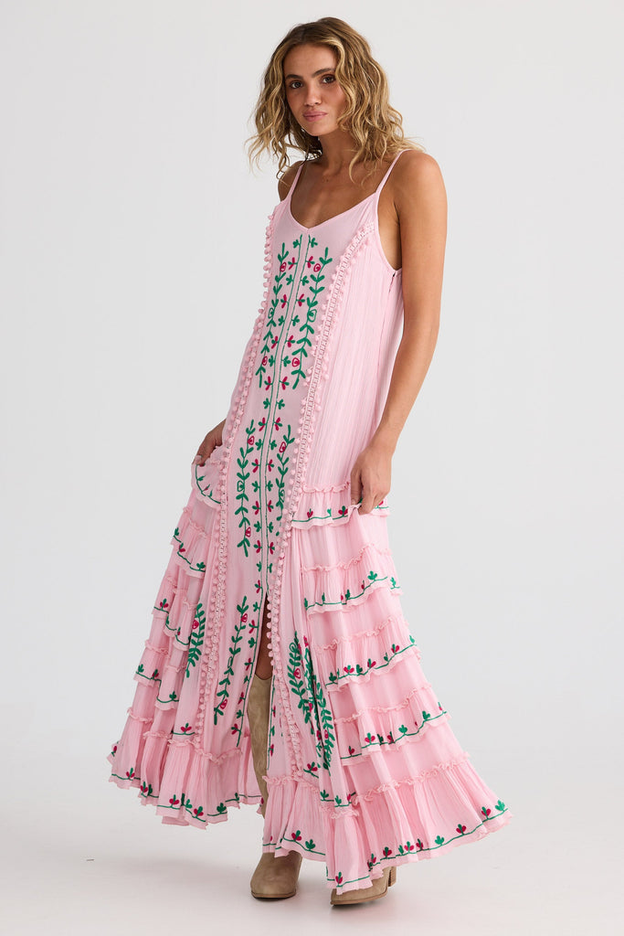 Woman wearing a pink floral dress on a white background
