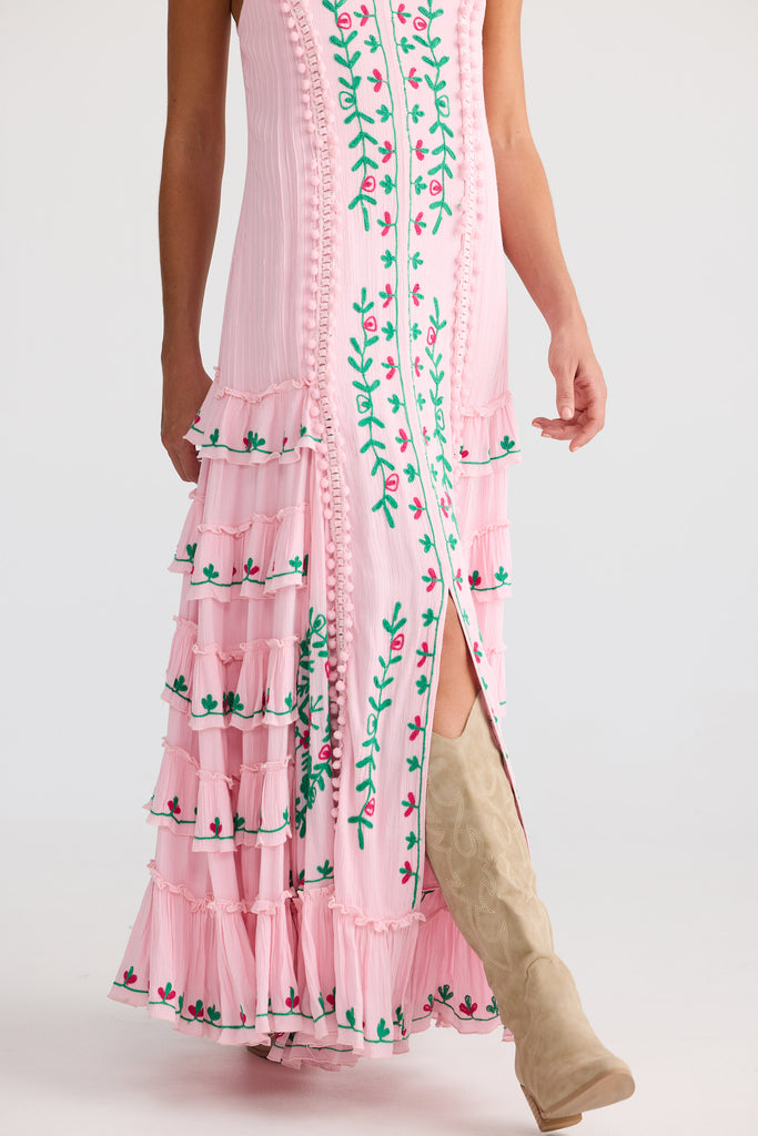 Pink dress with floral embroidery on a white background