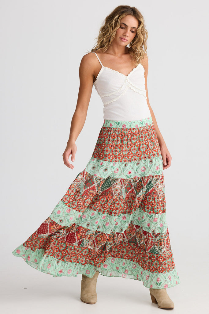 Woman wearing a floral tiered skirt on a white background