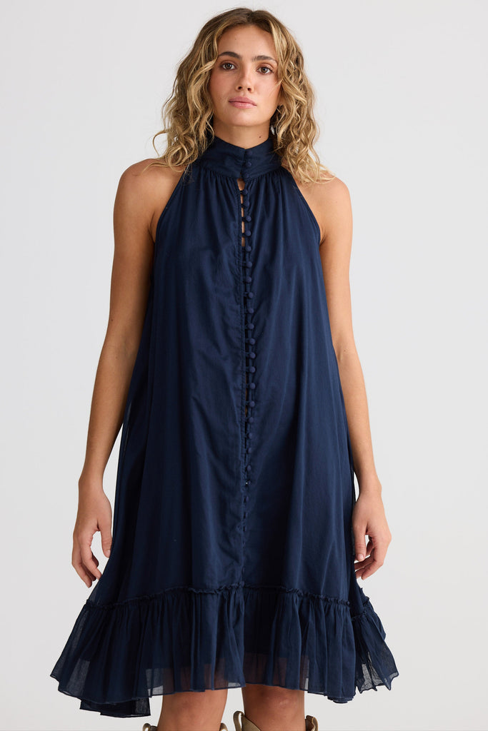 Woman wearing a navy blue dress on a white background