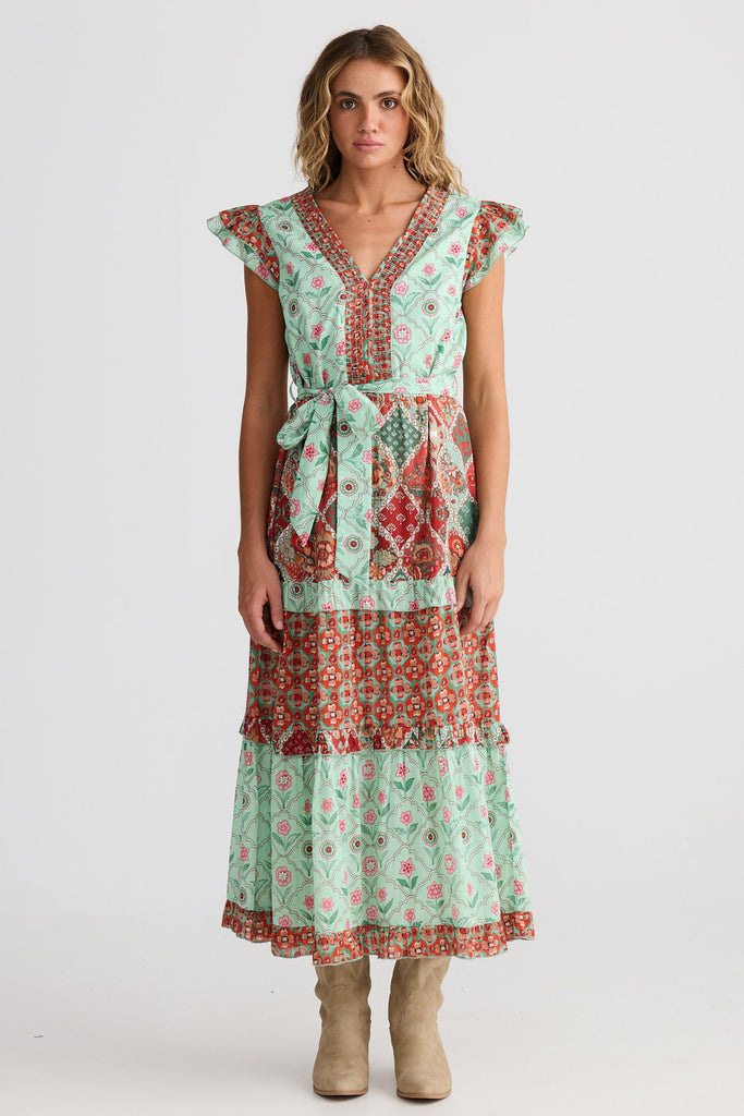 Woman wearing a patterned dress on a white background