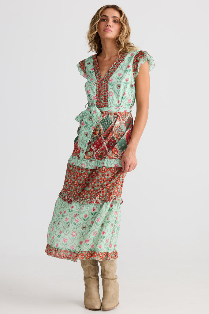 Woman wearing a patterned dress on a white background
