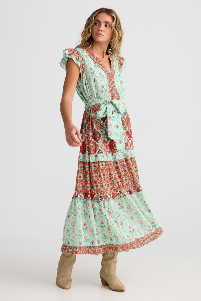 Woman wearing a floral dress with a white background