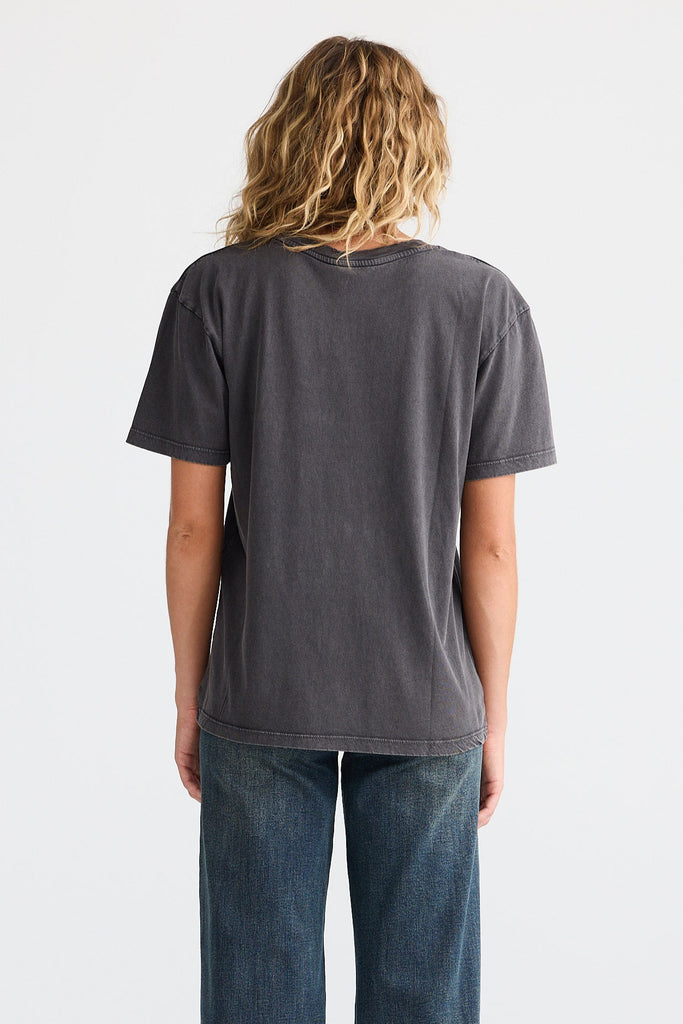 Person wearing a dark gray t-shirt and blue jeans on a white background