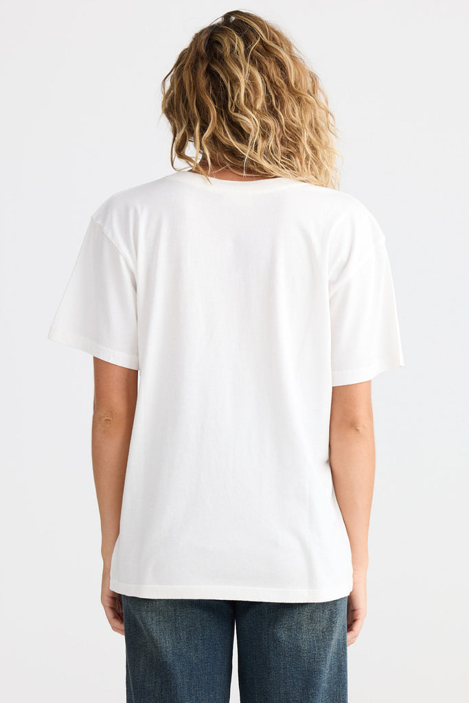 Person wearing a plain white t-shirt and blue jeans on a light gray background