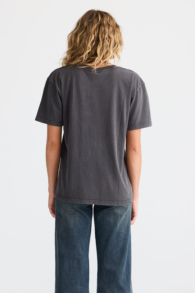 Person wearing a dark gray t-shirt and blue jeans on a white background