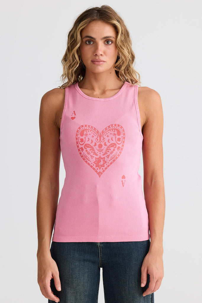 Woman wearing a pink tank top with a heart design on a white background