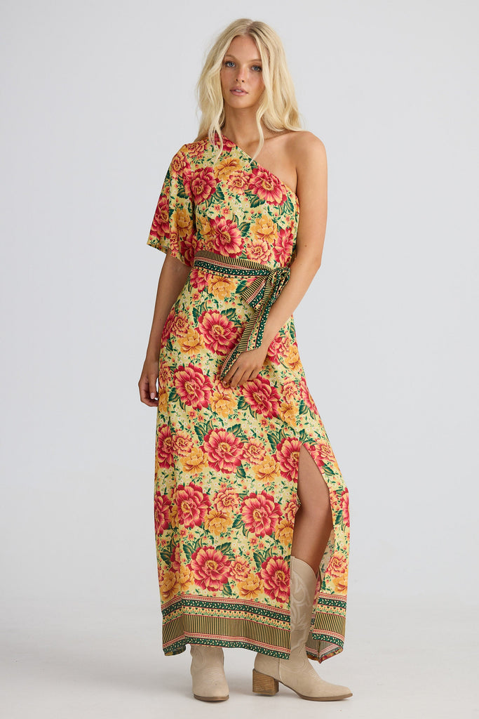 Woman wearing a colorful floral dress with a white background