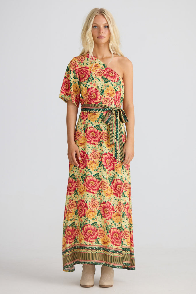 Woman wearing a floral one-shoulder dress on a white background