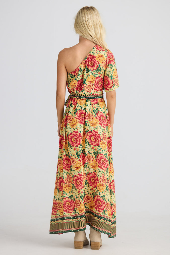 Woman wearing a floral one-shoulder dress on a white background