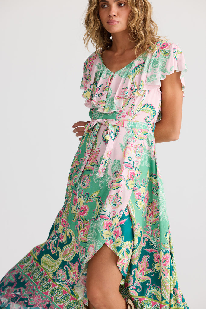 Woman wearing a colorful floral dress on a white background