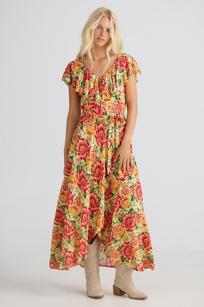 Woman wearing a colorful floral dress on a white background