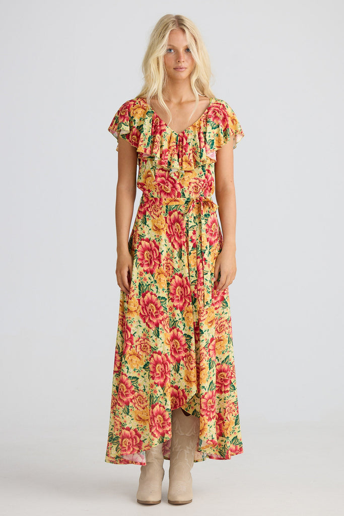 Woman wearing a colorful floral dress on a white background