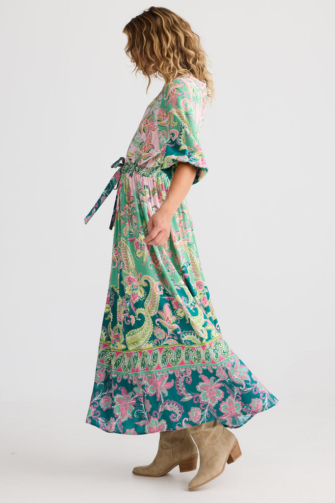 Woman wearing a floral dress with a white background