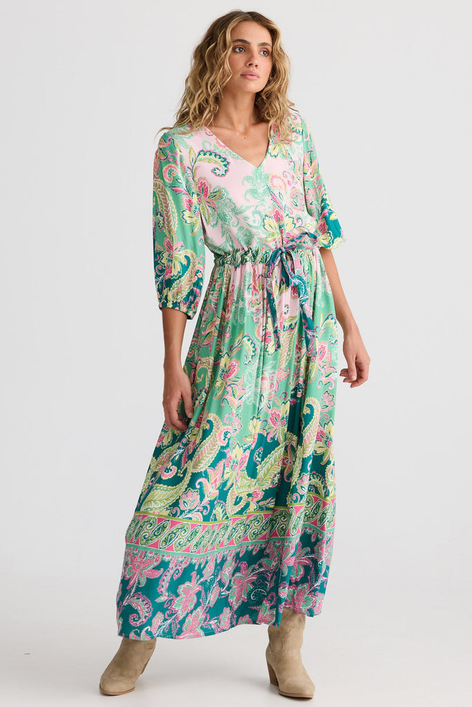 Woman wearing a colorful floral dress on a white background