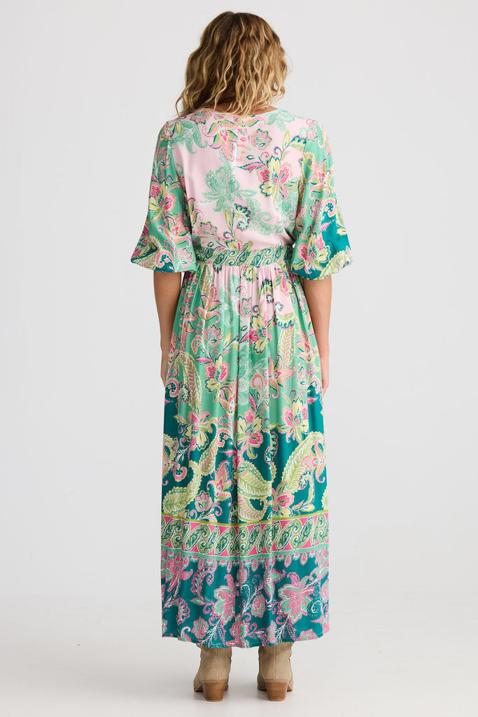 Woman wearing a floral dress with a white background