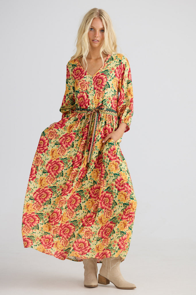 Woman wearing a floral dress on a plain background