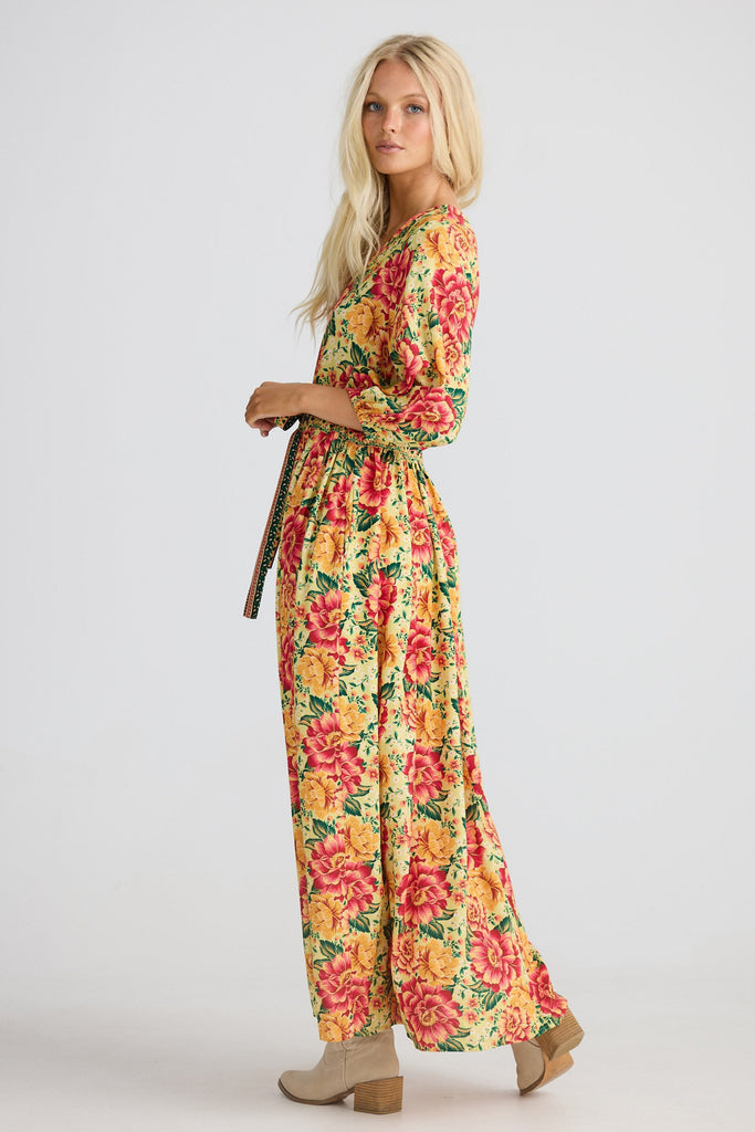Woman wearing a colorful floral dress on a white background