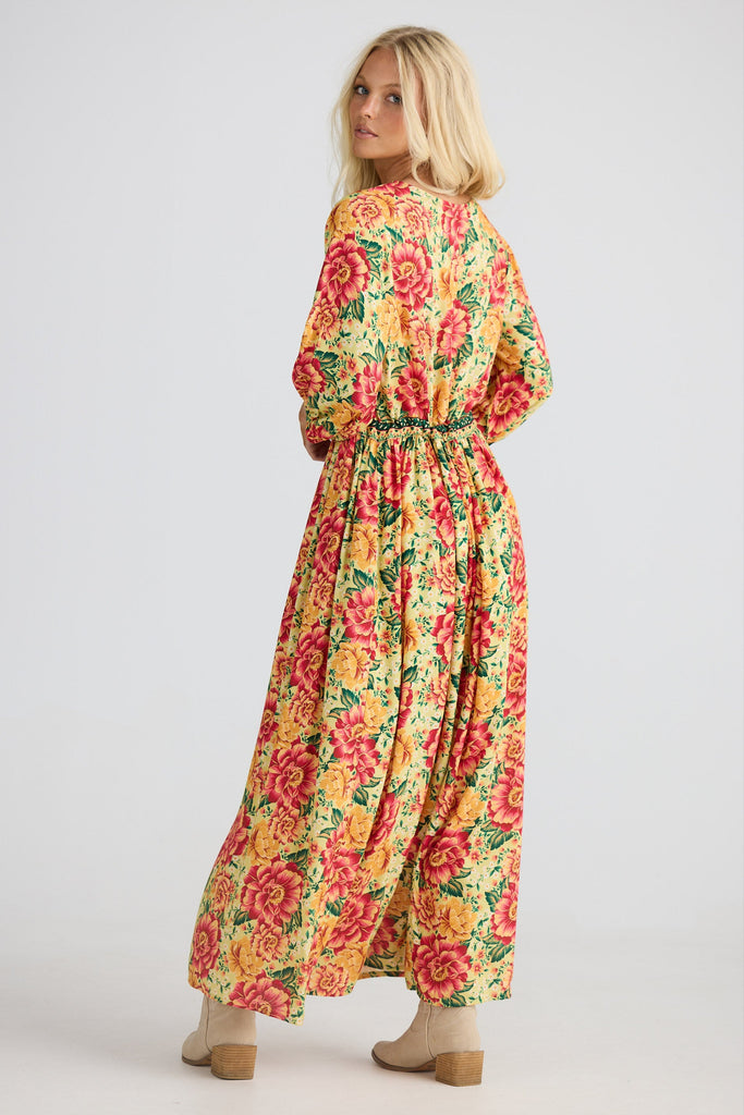 Woman wearing a floral dress on a white background