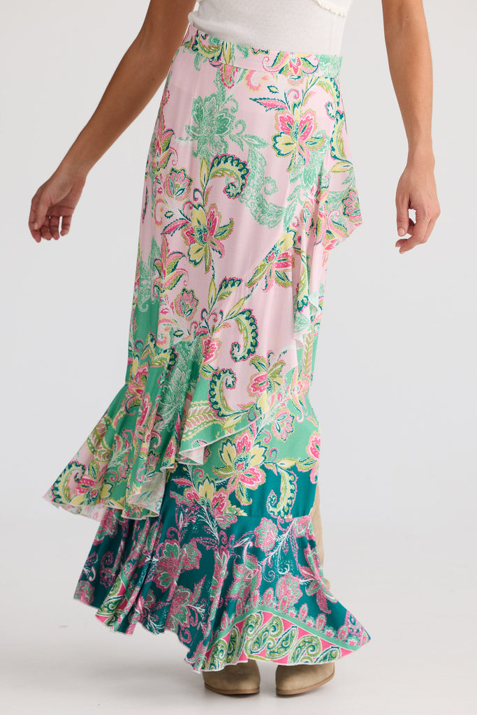 Woman wearing a colorful floral skirt on a white background