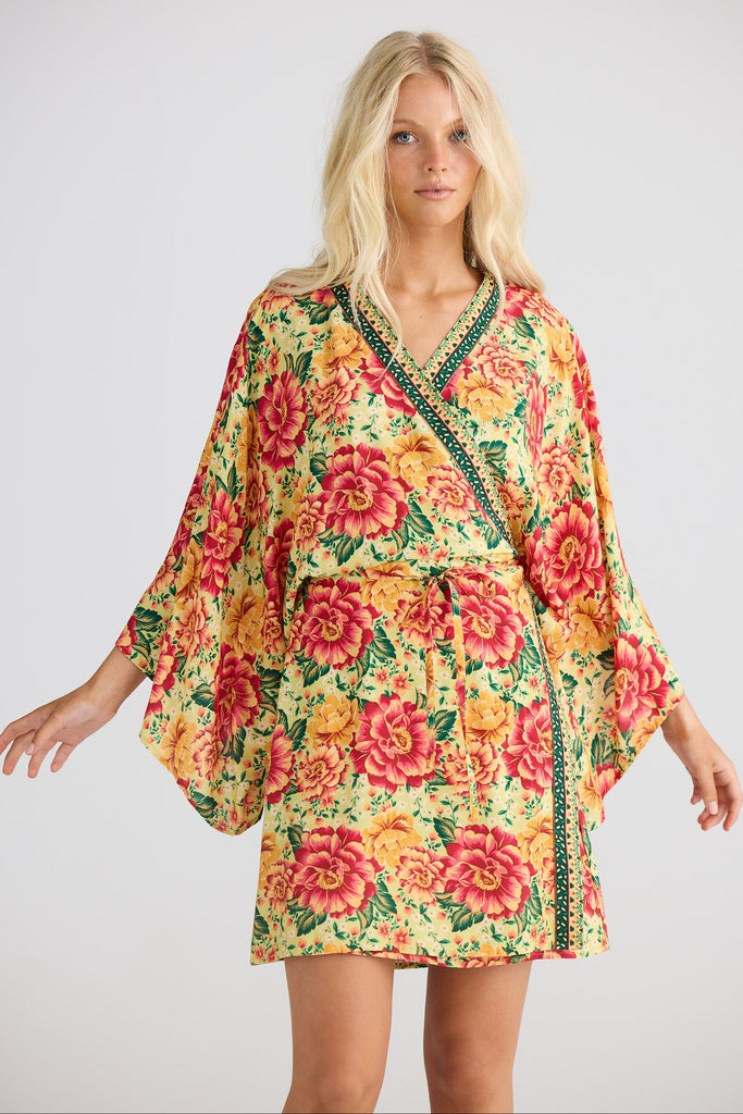 Woman wearing a floral dress with a plain background