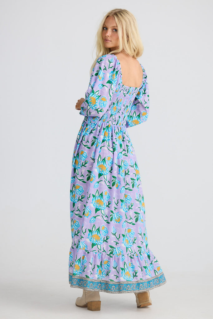 Woman wearing a floral dress on a white background
